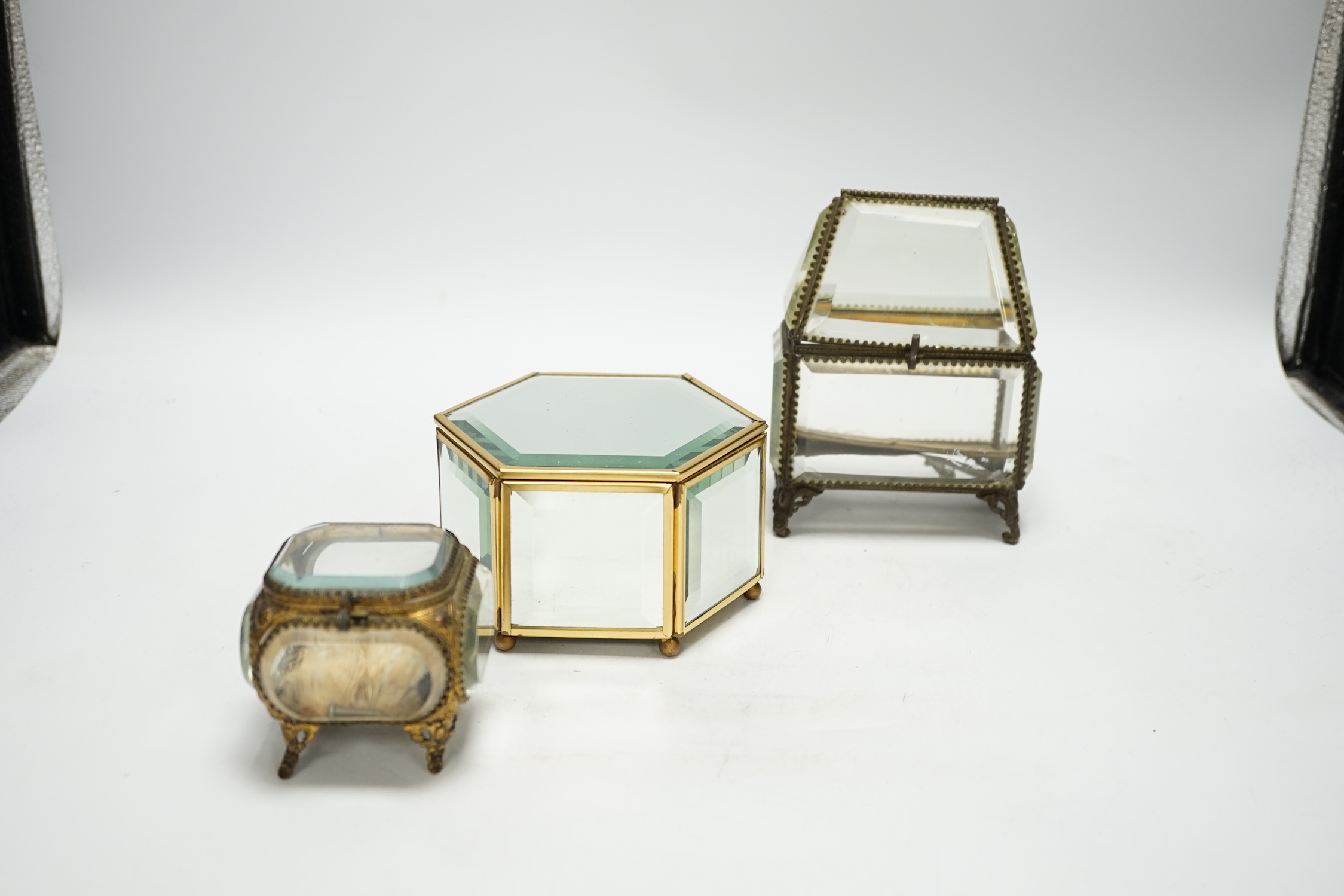 Three bevelled glass trinket boxes, tallest 15cm